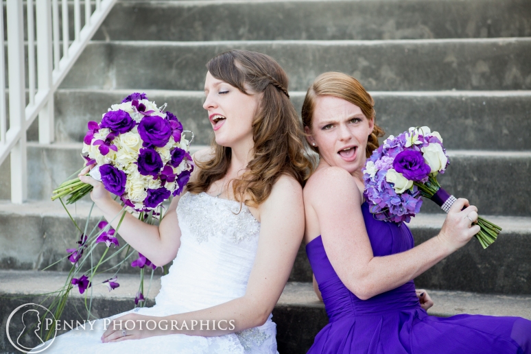 Sisters singing into bouquets at wedding