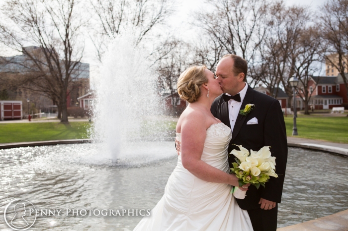 bride and groom by fountain at Earle Brown Event Center MN