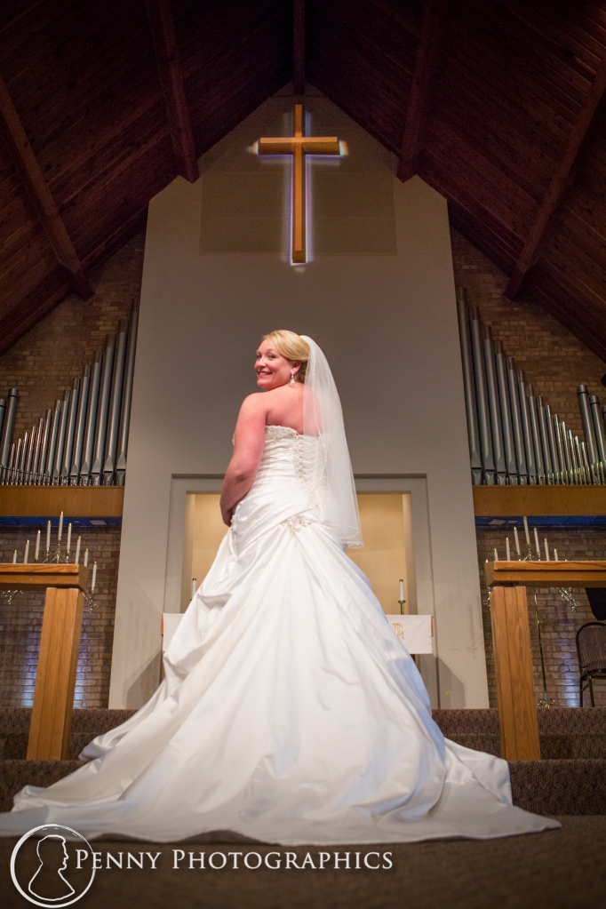 Bride standing at alter during portraits inside church MN