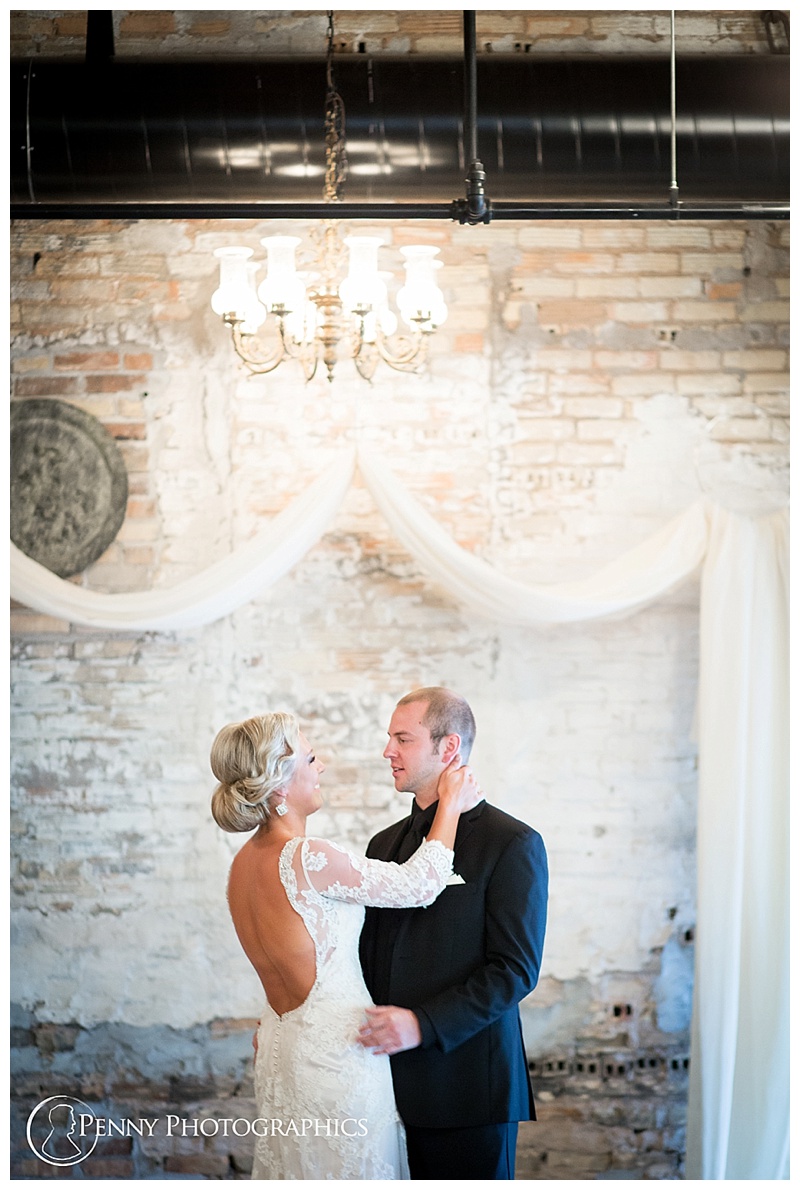 Kellerman Event Center Wedding couple against exposed brick and linen